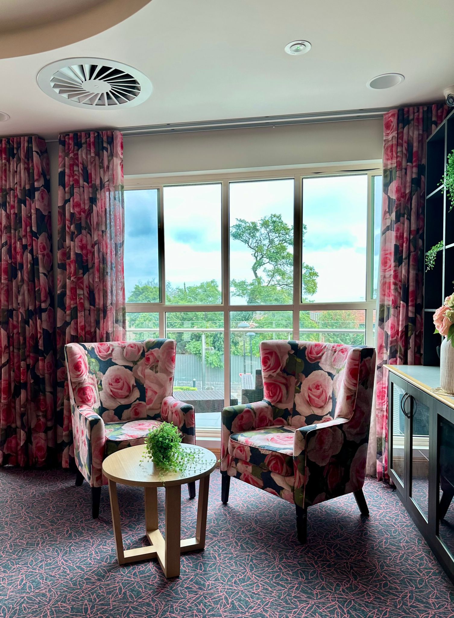 importance of design in an aged care setting. Custom upholstered chairs with coordinating curtains